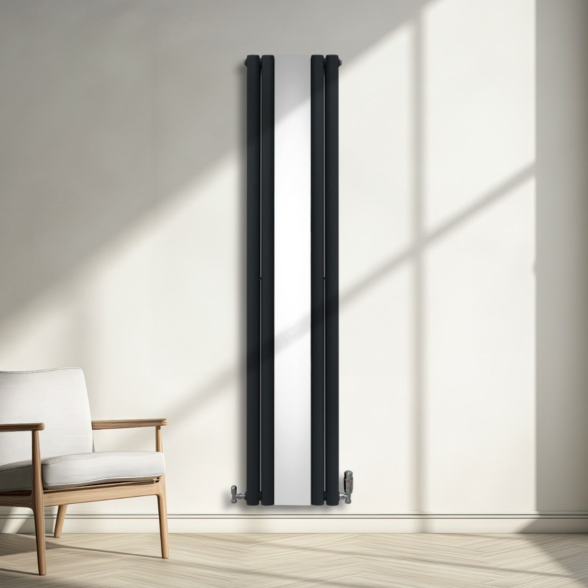 Radiateur à colonnes ovales gris anthracite avec miroir, vannes visibles, installé sur un mur lumineux, décor moderne et épuré