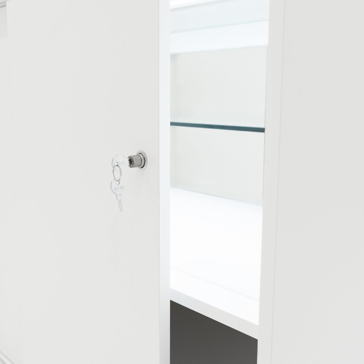 Comptoir de vente à LED blanc C1200, avec une porte ouverte, étagères intérieures et une clé en métal accrochée à la poignée