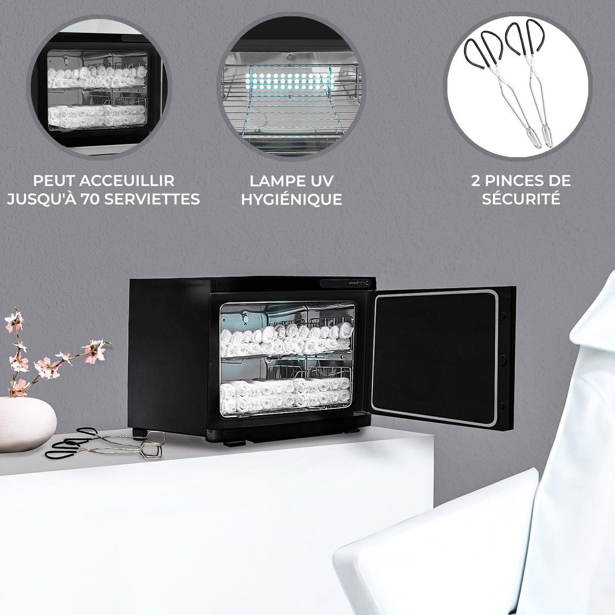 Chauffe-serviettes noir de 23 L avec porte ouverte, affichant des serviettes blanches et une lampe UV pour désinfection, sur fond gris