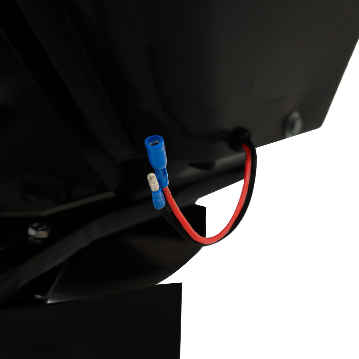 Détail d'un épandeur remorqué pour ATV, montrant un câble électrique noir avec connecteurs bleu et rouge, surface lisse et robuste