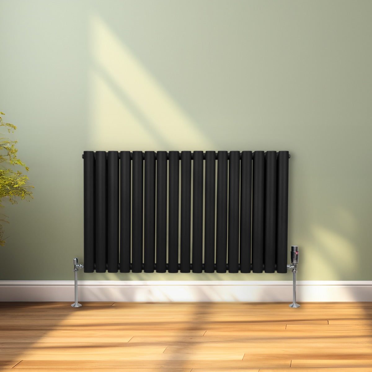 Radiateur à colonnes ovales noir, 2 panneaux, 600 x 1020 mm, installé contre un mur vert, avec un sol en bois clair et lumière naturelle