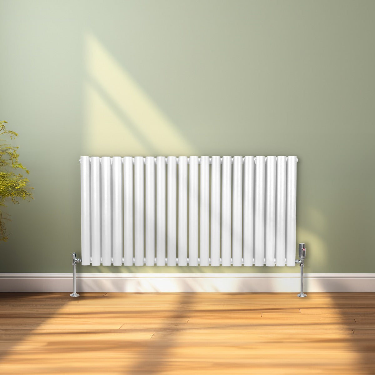 Radiateur à colonnes ovales blanc, 2 panneaux, 600 x 1200 mm, installé sur un mur vert, avec un sol en bois clair et lumière naturelle