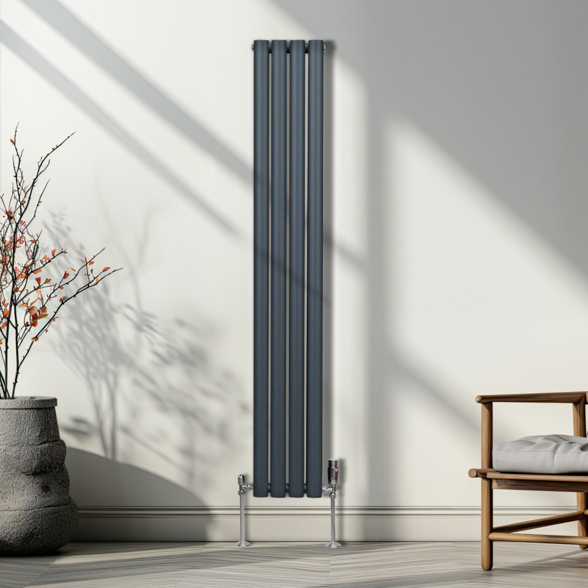 Radiateur à colonnes ovales gris anthracite, 2 panneaux, design moderne, surface lisse, installé contre un mur lumineux avec ombres douces