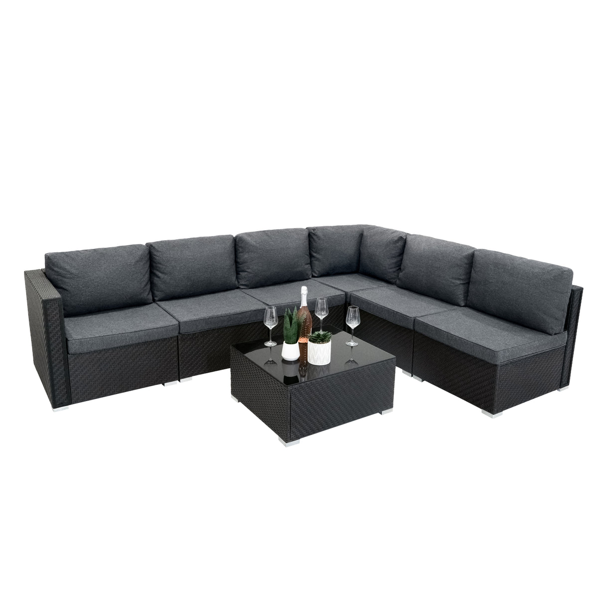 Salon de jardin modulaire en rotin noir avec coussins gris, comprenant un canapé en L et une table basse en verre, élégant et moderne