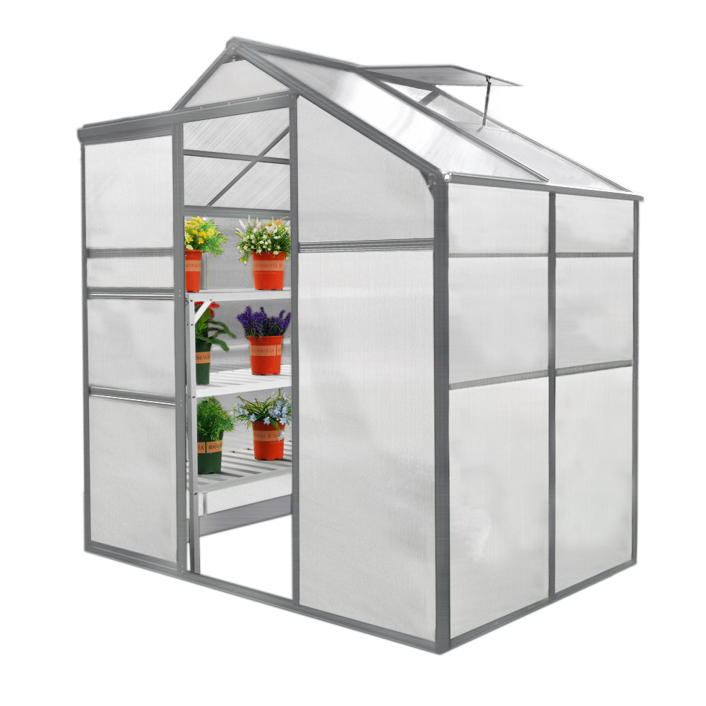 Serre de jardin en plastique transparent, 1,8 m x 1,2 m, avec étagères blanches et pots de fleurs colorés à l'intérieur