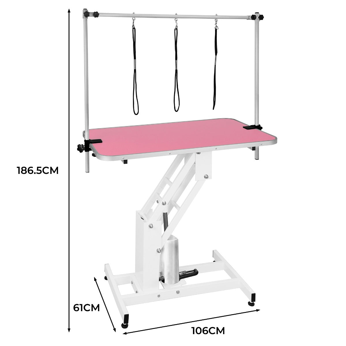 Table de toilettage hydraulique blanche avec plateau rose, dimensions 106 cm x 61 cm, équipée de sangles pour maintenir les animaux en place