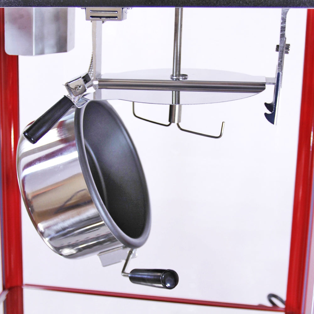 Machine à popcorn en inox rouge avec chariot, cuve en métal brillant suspendue, poignées noires, design vintage et élégant