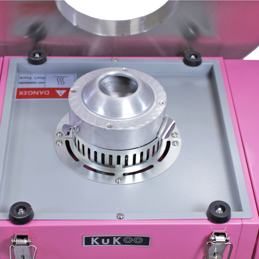 Machine à barbe à papa KuKoo en rose vif, avec un dôme protecteur transparent et un moteur en métal argenté, design compact et moderne