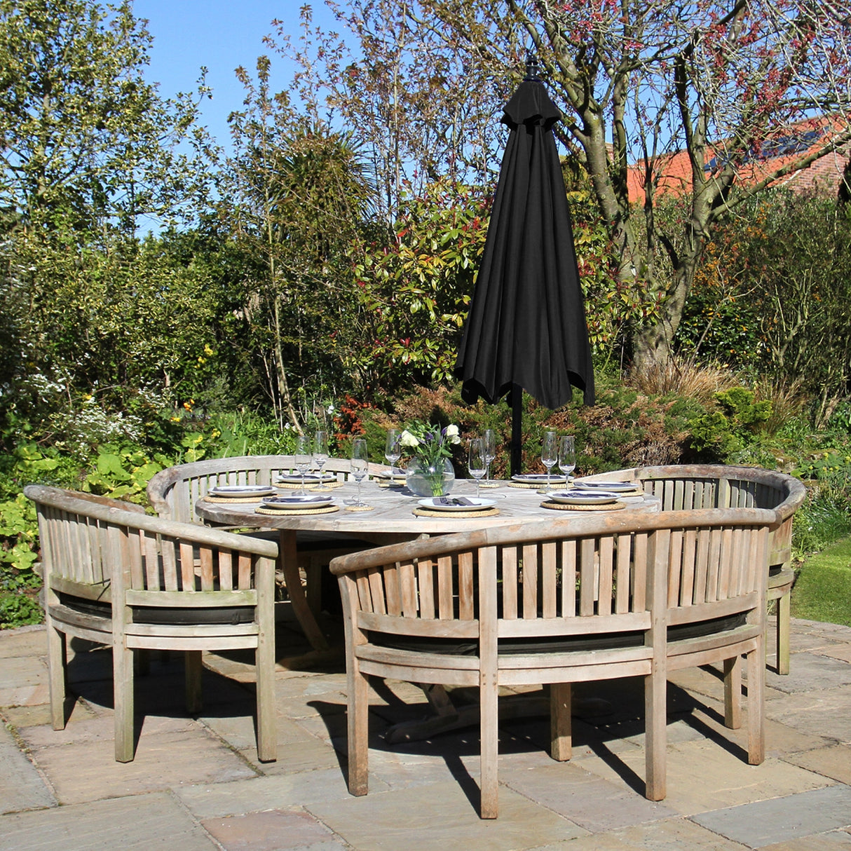 Parasol déporté noir de 3 m, élégant et fonctionnel, surplombant une table en bois entourée de chaises dans un jardin verdoyant