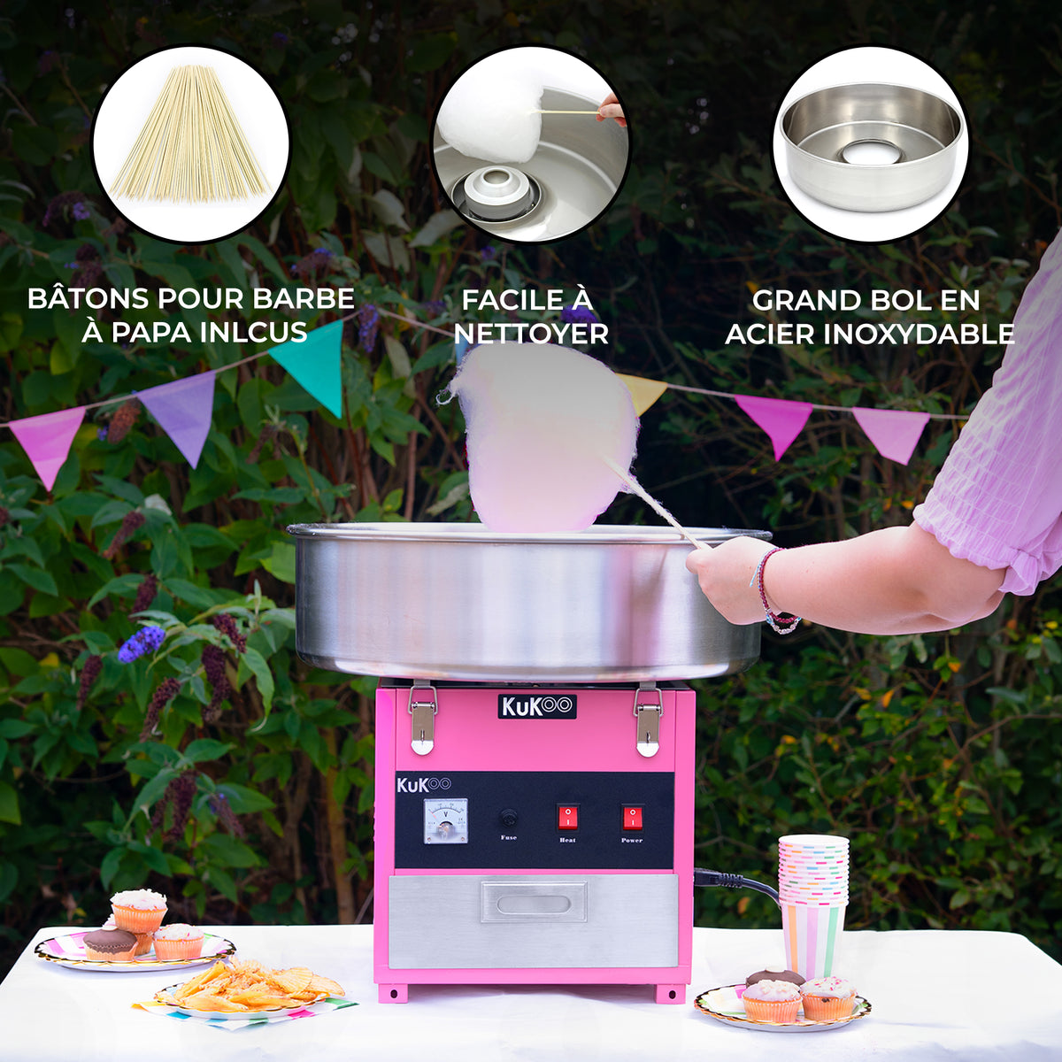 Machine à barbe à papa rose avec bol en acier inoxydable, accessoires inclus et une personne en train de préparer de la barbe à papa