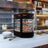 Vitrine chauffante noire avec étagères en verre, affichant des pizzas colorées, idéale pour conserver et présenter des plats chauds en restaurant