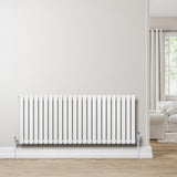 Radiateur à colonnes ovales blanc, 600 x 1440 mm, installé sur un mur clair, avec un sol en bois et un salon lumineux en arrière-plan