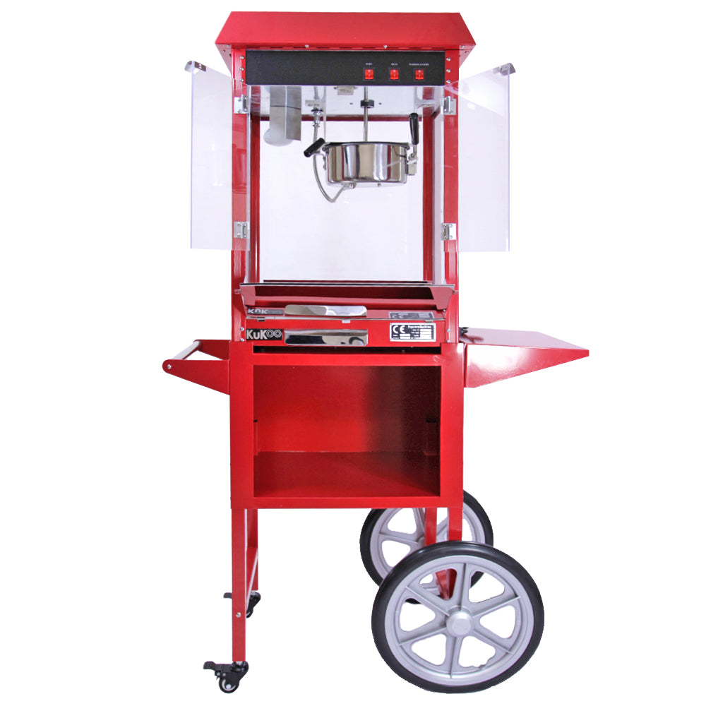 Machine à popcorn KuKoo rouge vif avec chariot, vitres transparentes, et cuve en métal brillant, idéale pour les fêtes et événements